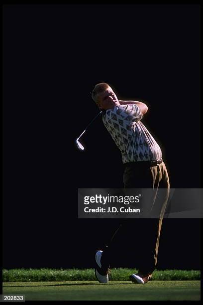 Golfer John Daly watches his drive during the Nissan Open at the Riviera Country Club in Pacific Palisades, California. Daly finished even with a...