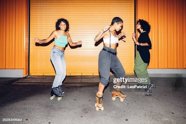 three freestyler on roller skate dancing at night - friends roller skating stock pictures, royalty-free photos & images