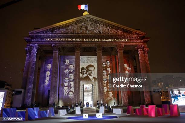 Members of the French Republican Guard carry the coffins as images are projected during a state ceremony for the induction into The Pantheon of...