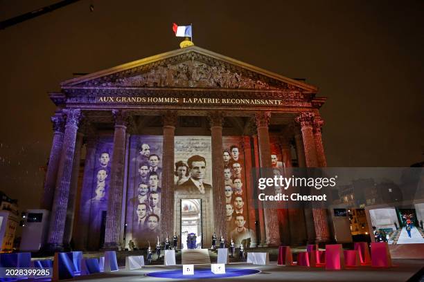 Members of the French Republican Guard carry the coffins as images are projected during a state ceremony for the induction into The Pantheon of...