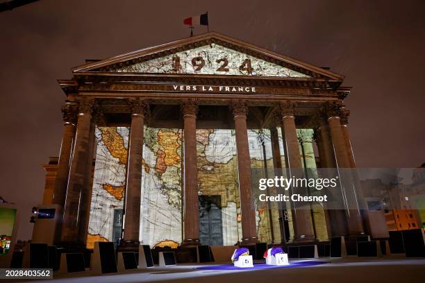 Coffins of Missak Manouchian and his wife Mélinee Manouchian lay outside the Pantheon monument as images are projected during the induction ceremony...