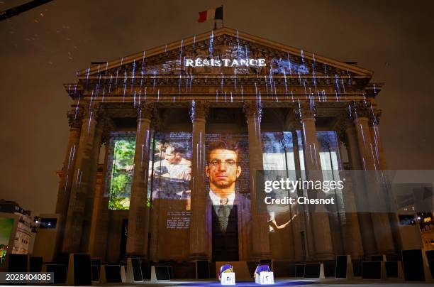 Coffins of Missak Manouchian and his wife Mélinee Manouchian lay outside the Pantheon monument as images are projected during the induction ceremony...