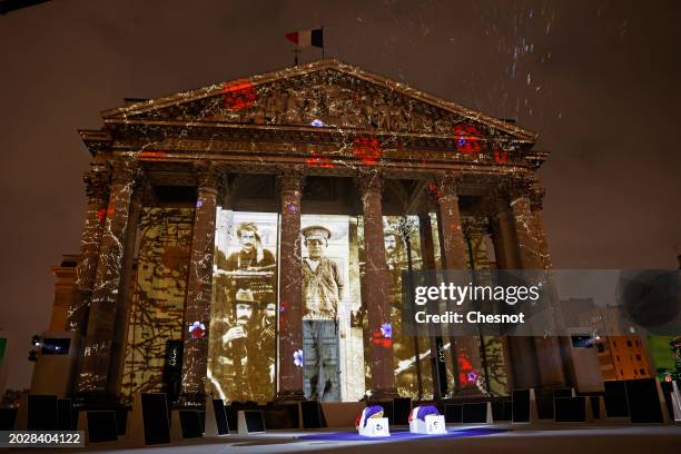 Coffins of Missak Manouchian and his wife Mélinee Manouchian lay outside the Pantheon monument as images are projected during the induction ceremony...