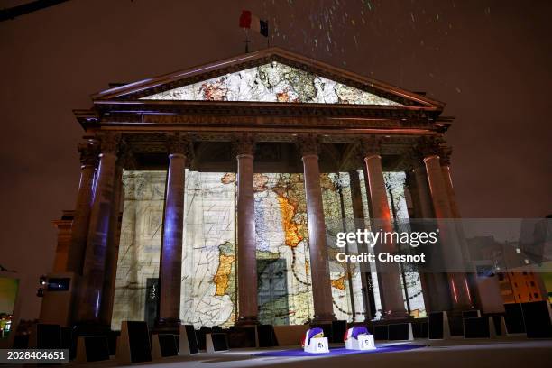 Coffins of Missak Manouchian and his wife Mélinee Manouchian lay outside the Pantheon monument as images are projected during the induction ceremony...