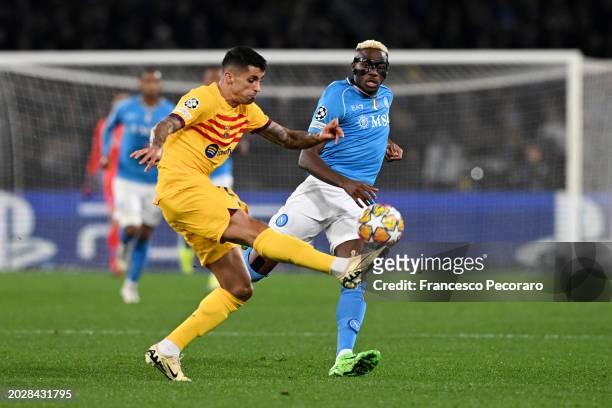 Joao Cancelo of FC Barcelona clears the ball whilst under pressure from Victor Osimhen of SSC Napoli during the UEFA Champions League 2023/24 round...