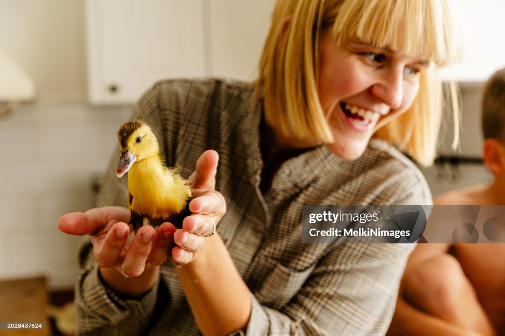 Woman holding young duck