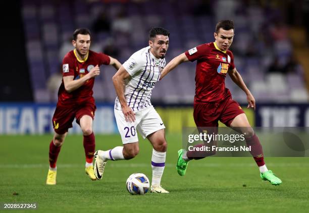 Matias Palacios of Al Ain runs with the ball whilst under pressure from Akmal Mozgovoy of FC Nasaf during the AFC Champions League match between Al...