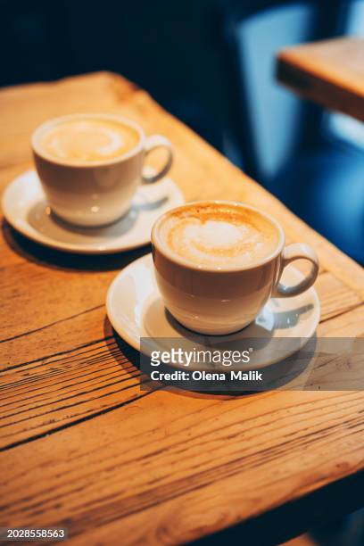 two coffee cups with latte art. lifestyle concept - wicker heart stock pictures, royalty-free photos & images