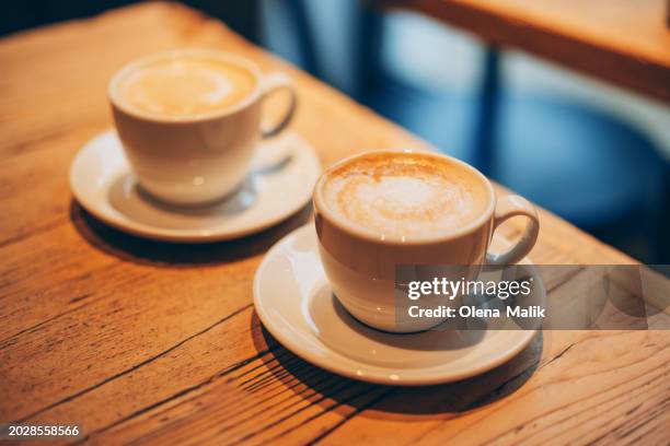 two coffee cups with latte art. lifestyle concept - wicker heart stock pictures, royalty-free photos & images