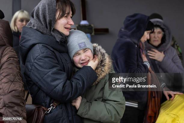Liliya Katanenko holds her crying son Matviy at a funeral for her husband Andriy Katanenko who was killed near Avdiivka on February 21st on February...