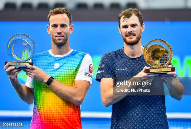 Jamie Murray from Great Britain and Michael Venus from New Zealand are posing with their trophy after winning the doubles final match against Lorenzo...