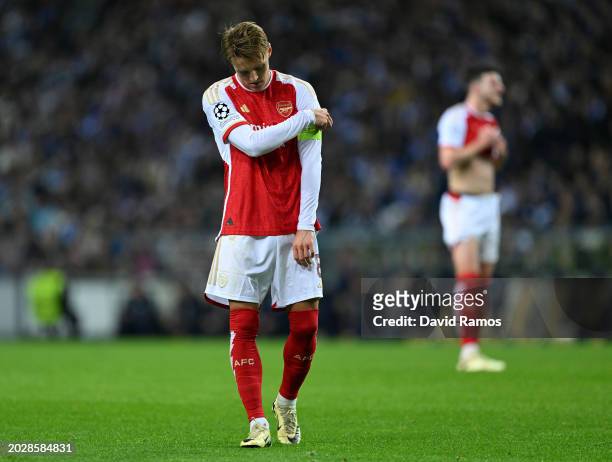 Martin Odegaard of Arsenal looks dejected as he adjusts his captains armband during the UEFA Champions League 2023/24 round of 16 first leg match...