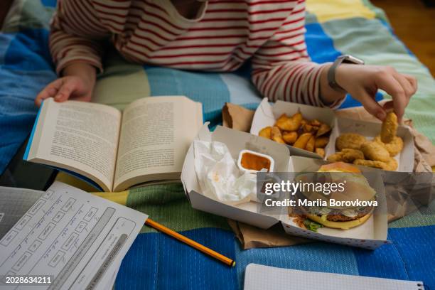 cozy reading and snacking session with fast food on a comfortable bed - chicken strip stock pictures, royalty-free photos & images