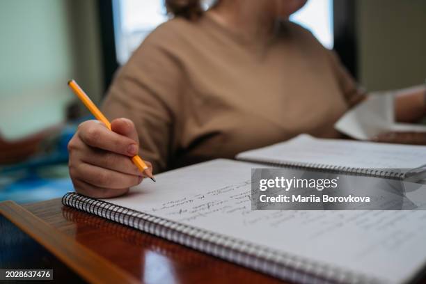 young woman studying in her dorm room - beca fotografías e imágenes de stock