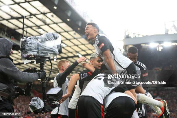 Rodrigo Muniz of Fulham celebrates with teammates after their 1st goal during the Premier League match between Manchester United and Fulham FC at Old...