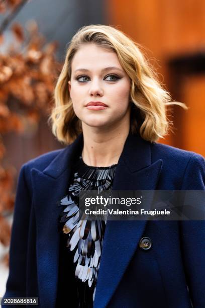 Guest is seen wearing a black sequins top and a blue long coat outside the Alberta Ferretti show during the Milan Fashion Week - Womenswear...