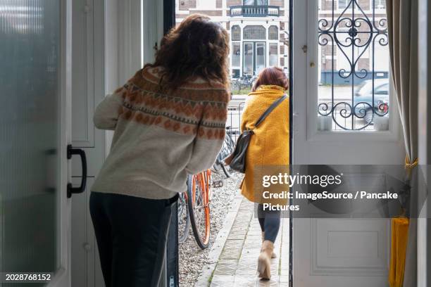 saying goodbye to mother in law, waving from the front door - door way stock pictures, royalty-free photos & images