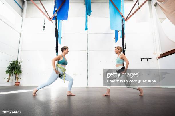 two female athletes with bungee cords - woman bungee jumping stock pictures, royalty-free photos & images