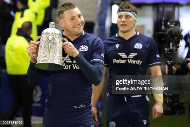 Co-captains, Scotland's fly-half Finn Russell and Scotland's flanker Rory Darge collect the Calcutta Cup after the Six Nations international rugby...