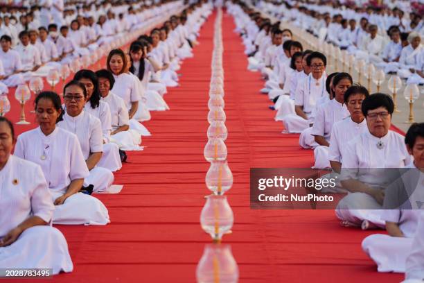 Thai Buddhist devotees are chanting during a religious ceremony to mark Makha Bucha Day at Wat Phra Dhammakaya Temple in Pathum Thani province, on...