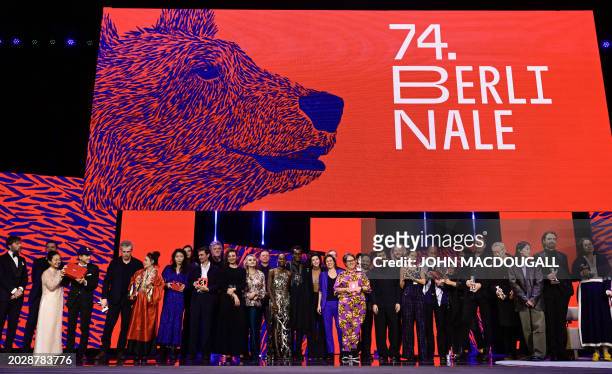 All the 2024 laureates pose on stage at the end of the awards ceremony of the 74th Berlinale International Film Festival, on February 24, 2024 in...