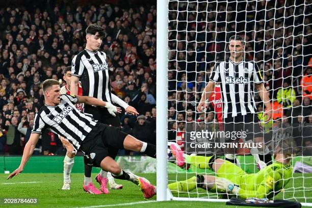 Newcastle United's Dutch defender Sven Botman manages to kick the ball over his own line for an own-goal after a good save from Newcastle United's...