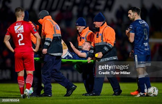 Sligo , Ireland - 24 February 2024; Cameron Dummigan of Derry City is stretchered off the pitch after picking up an injury during the SSE Airtricity...