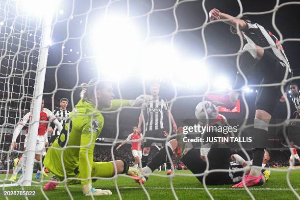 Newcastle United's English defender Valentino Livramento kicks the ball onto the knee of Newcastle United's Dutch defender Sven Botman who manages to...