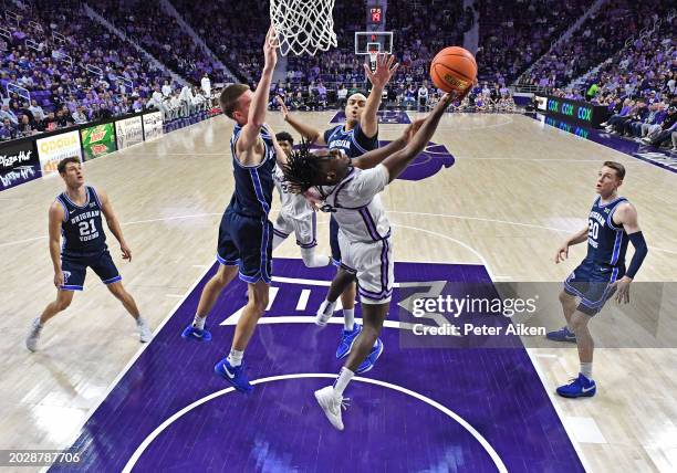 Arthur Kaluma of the Kansas State Wildcats goes to the basket against pressure from Noah Waterman of the Brigham Young Cougars in the first half at...