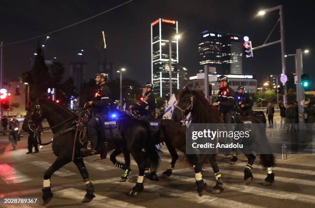 Demonstrators against the government of Prime Minister Benjamin Netanyahu wave Israeli flags and banners demanding early elections as Israeli police...