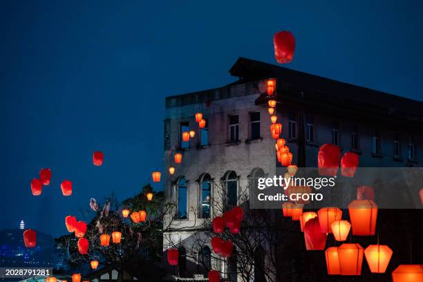 Chinese citizens and international friends release Kongmin lanterns to celebrate the Lantern Festival in Chongqing, China, February 24, 2024.