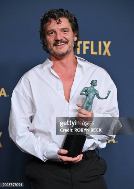 Chilean-US actor Pedro Pascal poses in the press room with the award for Outstanding Performance by a Male Actor in a Drama Series for "The Last of...