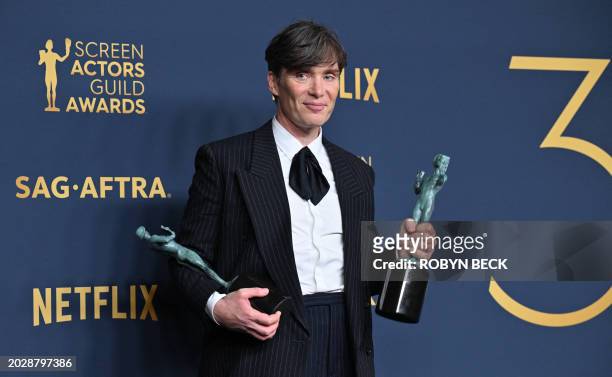 Irish actor Cillian Murphy poses in the press room with the awards for Outstanding Performance by a Male Actor in a Leading Role in a Motion Picture...