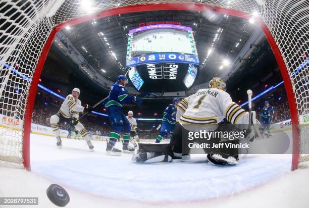 Brock Boeser of the Vancouver Canucks scores a goal on Jeremy Swayman of the Boston Bruins during the third period of their NHL game at Rogers Arena...