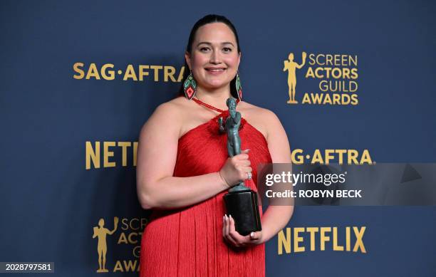 Actress Lily Gladstone poses in the press room with the award for Outstanding Performance by a Female Actor in a Leading Role in a Motion Picture for...