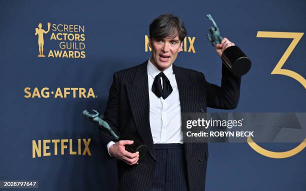 Irish actor Cillian Murphy poses in the press room with the awards for Outstanding Performance by a Male Actor in a Leading Role in a Motion Picture...