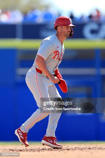 Philadelphia Phillies infielder Whit Merrifield leads off second base and then takes off for third base during the spring training game between the...