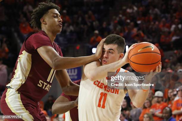 Florida State Seminoles forward Baba Miller fouls Clemson Tigers guard Joseph Girard III during a college basketball game between the Florida State...