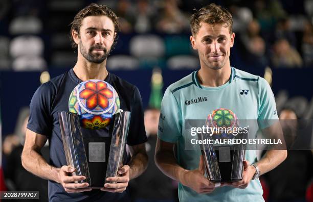 Australia's Jordan Thompson poses with the winner's trophy with runner-up Norway's Casper Ruud following their men's singles final of the ATP 250...