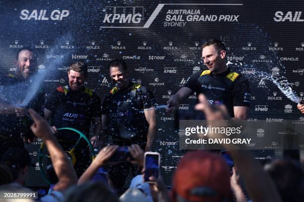 The crew of SailGP team Australia celebrate their victory with champagne after the final race of the Sail Grand Prix event on Sydney Harbour on...