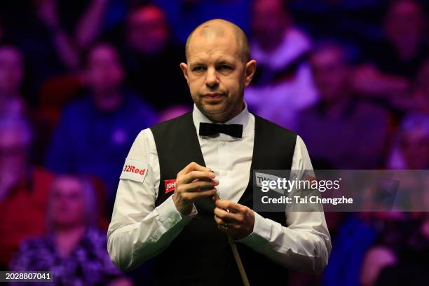 Barry Hawkins of England chalks the cue in the first round match against Mark Selby of England on day three of 2024 Players Championship at Telford...