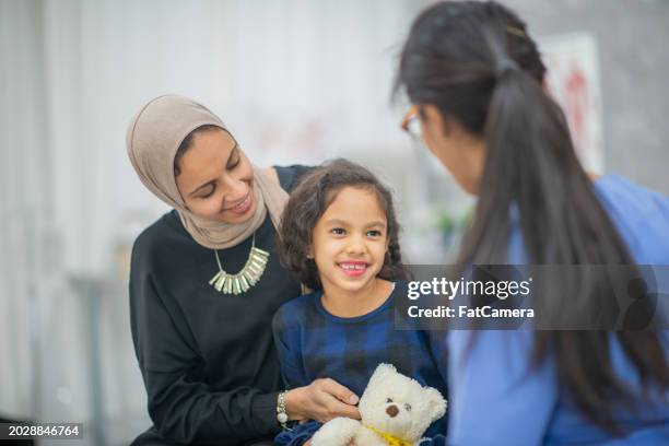 visiting the doctor with mom - afghan girl stock pictures, royalty-free photos & images