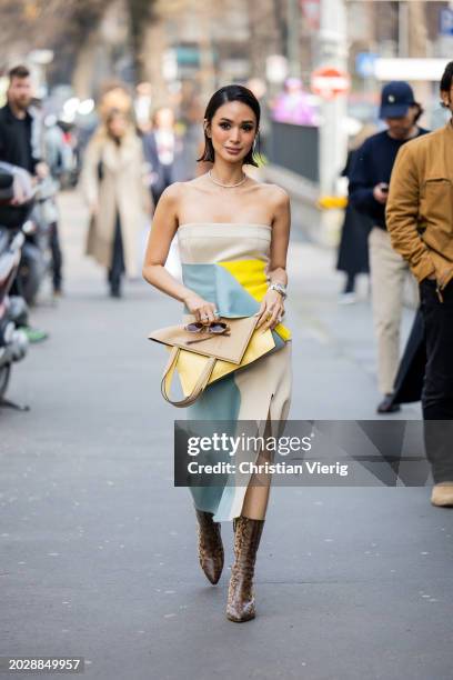 Heart Evangelista wears off shoulder beige blue yellow dress with slit, bag, animal print ankle boots outside Fendi during the Milan Fashion Week -...