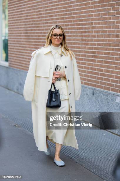 Julia Comil wears beige coat, skirt, black bag outside Fendi during the Milan Fashion Week - Womenswear Fall/Winter 2024-2025 on February 21, 2024 in...