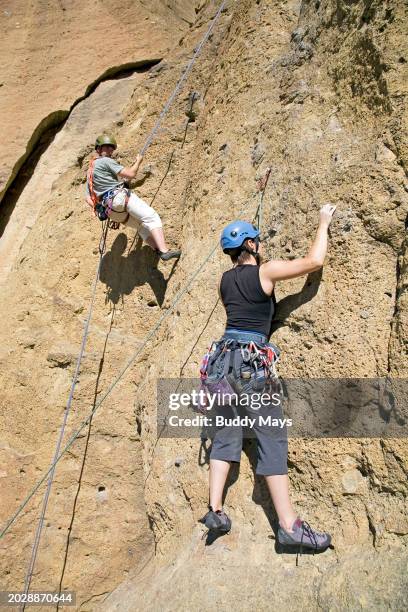 Rock climbers head for the cliffs at Smith Rock State Park along the Crooked River, one of the Northwest's principal technical rock-climbing areas,...