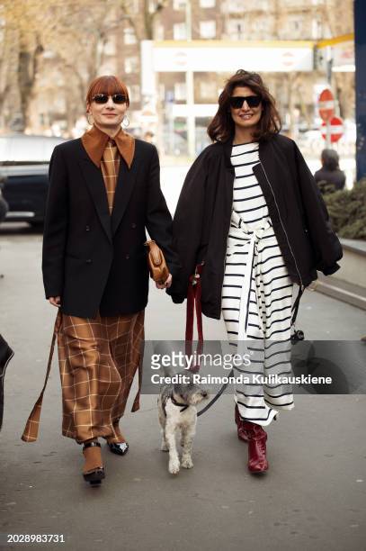 Guests walking with the dog outside Fendi during the Milan Fashion Week - Womenswear Fall/Winter 2024-2025 on February 21, 2024 in Milan, Italy.