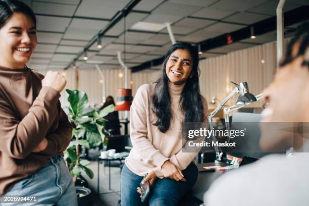 happy female business professionals enjoying during team meeting at office - povo indiano imagens e fotografias de stock