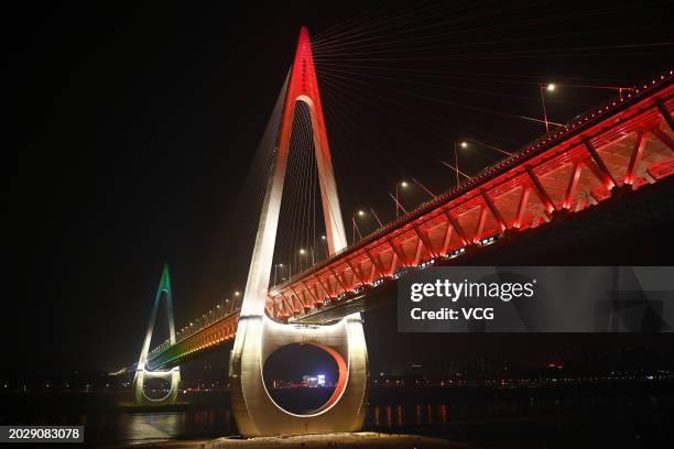 Chongqing Baijusi Yangtze River Bridge is illuminated at night on February 20, 2024 in Chongqing, China. The Baijusi Yangtze River Bridge with a...