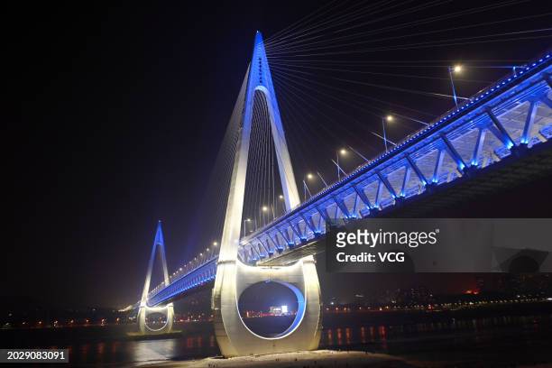 Chongqing Baijusi Yangtze River Bridge is illuminated at night on February 20, 2024 in Chongqing, China. The Baijusi Yangtze River Bridge with a...
