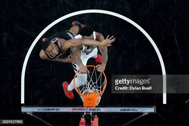 Jamille Reynolds of the Cincinnati Bearcats dunks the ball past Quion Williams of the Oklahoma State Cowboys in the second half at Fifth Third Arena...